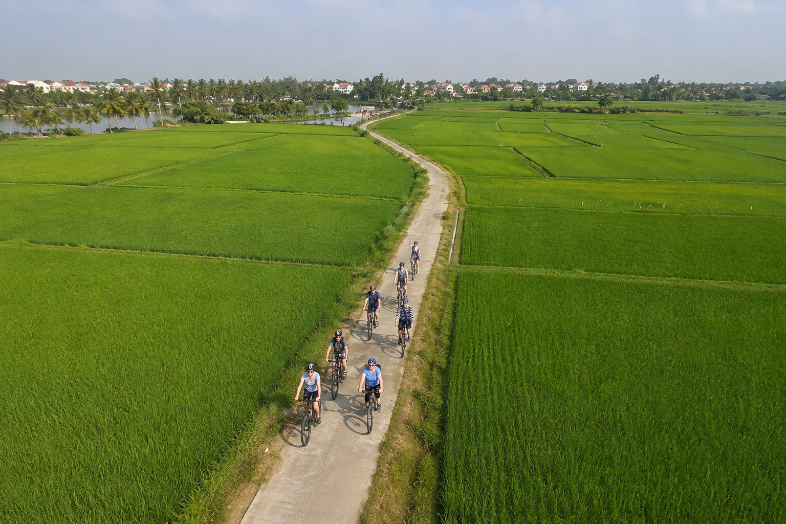 Travelers cycling through Hoi An countryside in the early morning