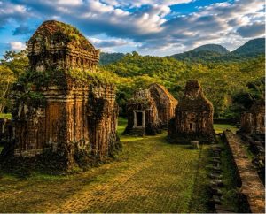 Early morning sunlight illumination over ancient Champa temple ruins in B C D groups at My Son Sanctuary under a blue sky